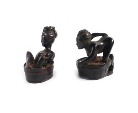 A 20th century Japanese netsuke modelled as a female figure taking a bath, h. 4.5 cm, together with a similar erotic figure (