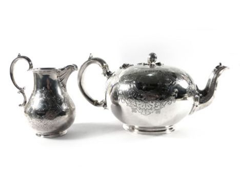 A Victorian silver and parcel gilt three piece tea service of ovoid form, the teapot having a melon finial and all over engra