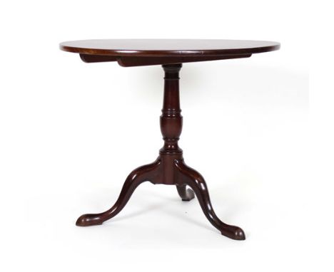 A George III mahogany tilt-top table, the oval surface on a turned column and tripod base, w. 92 cm   CONDITION REPORT:  Brac