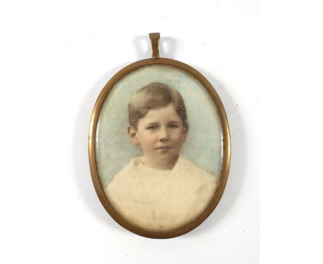 A late 19th century pendant containing a miniature overpainted photograph head and shoulders portrait by T.Fall, a locket of 