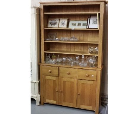 Modern light oak Dresser with a boarded shelf back with adjustable shelves, above three drawers and three cupboard doors, 122