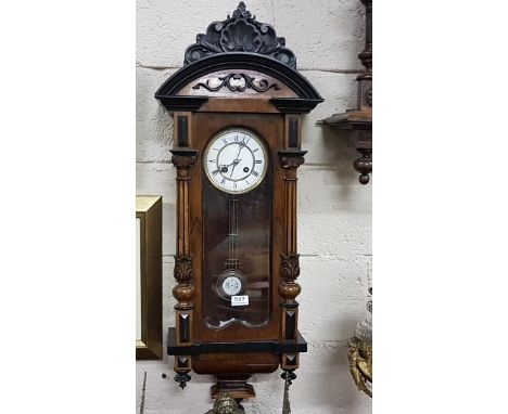 Victorian Walnut and Ebonised Vienna Wall Clock, the enamel dial with Roman numerals with a two train striking movement, 100c