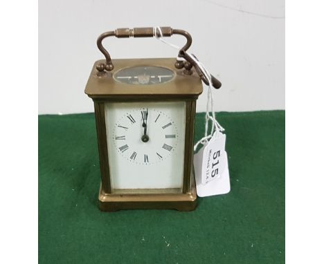 Brass framed Carriage Clock, white dial, with a key