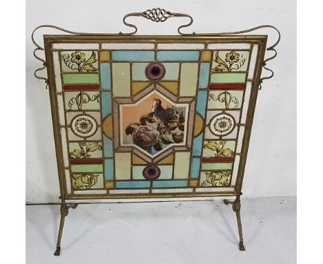 Late 19th C Firescreen, brass framed with stained glass coloured panes featuring flowers and a central bird (bird panel damag