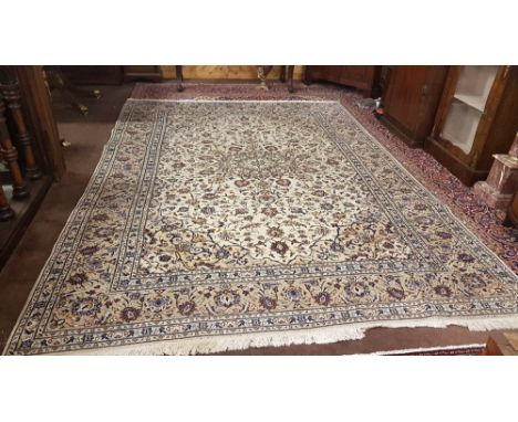 Cream Ground Persian Kashan Carpet, with a traditional Iranian design and blue borders, 3.42m x 2.45m