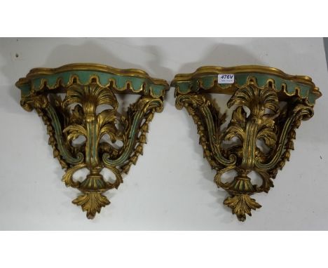 A pair of Continental Polychrome and gilt Wall Brackets, each with serpentine shelf decorated with flowerheads and foliage hu