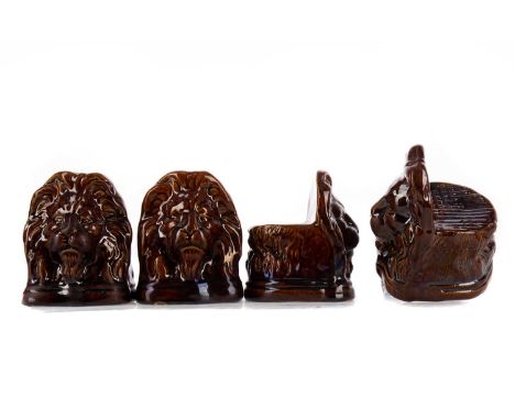 SET OF FOUR VICTORIAN STAFFORDSHIRE SASH WINDOW SUPPORTS,each modelled in the form of a lion's head, in treacle glaze, 13.5cm