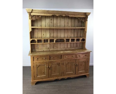 LARGE STRIPPED PINE DRESSER,the dentil moulded cornice above carved grape and vine brackets, two shelves and pigeonholes, the