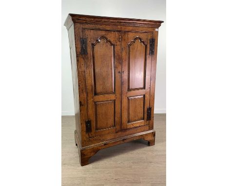 18TH CENTURY AND LATER OAK FREESTANDING CUPBOARD,the twin panelled doors with iron H-hinges and enclosing two shelves, raised