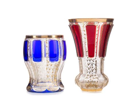 LATE 19TH CENTURY BOHEMIAN GLASS BEAKER,of faceted trumpet form, with cased ruby panels, richly gilded throughout, polished p