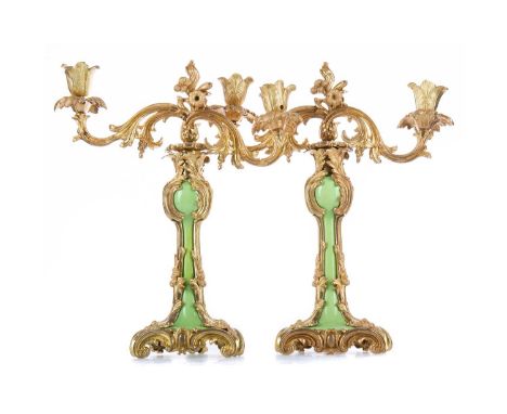 PAIR OF LATE 19TH/ EARLY 20TH CENTURY GILT METAL TWIN BRANCH CANDELABRA,of Rococo design, with pale green column support, on 