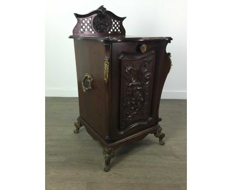 EDWARDIAN MAHOGANY COAL PURDONIUM,with raised pierced back, carved front panel, gilt metal mounts and twin handles, raised on