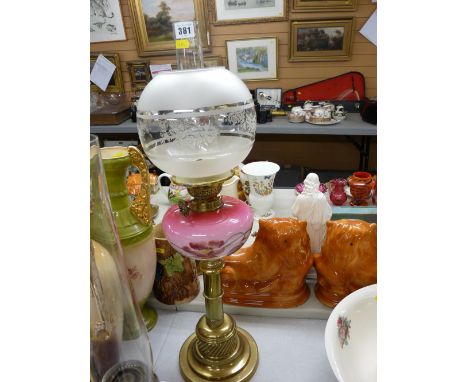 Victorian brass column oil lamp with painted pink glass font, cone wick adjusters and a later etched globular shade