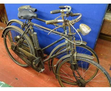 Two vintage bicycles, one Raleigh with steel tubing, three speed gears and Dynamo lighting system