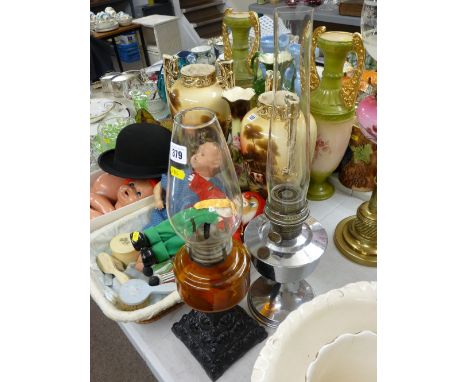 Cast iron based vintage oil lamp with glass font and funnel and a chrome plated example with funnel