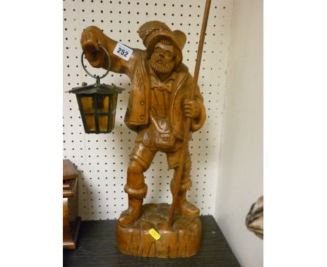 Excellent carved figure of a Continental gentleman holding a spear and lamp