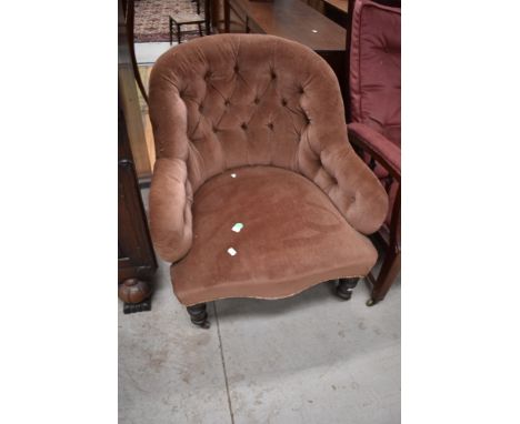 A Victorian low seat arm chair having button back dralon upholstery