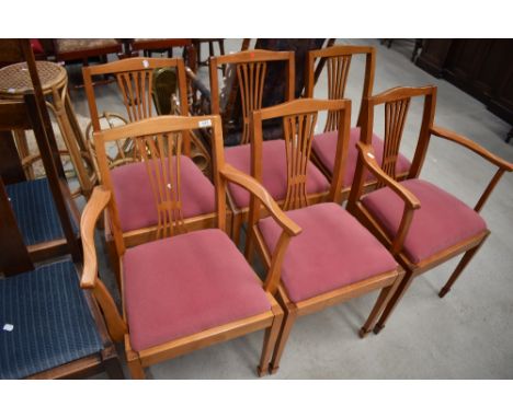 A set of six (four plus two) light stained dining chairs having feather style slat back, upholstered drop in seats in pink dr