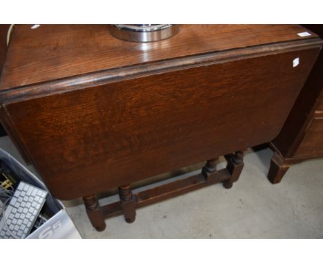 An early to mid 20th Century oak twist gate leg dining table