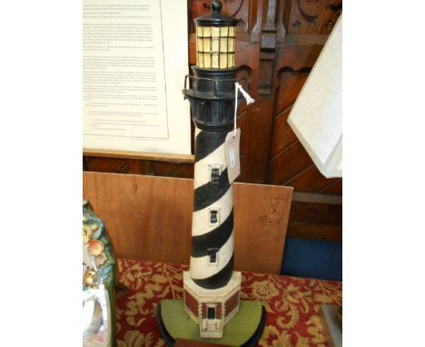 A painted cast iron door-stop in the form of a light house