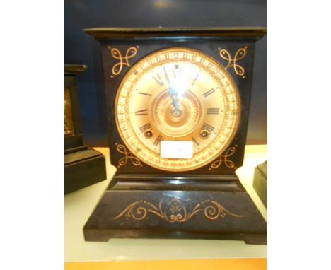 A 19th C Ansonia clock company slate mantle clock with brass dial and Roman numerals and flanked by floral scrolls