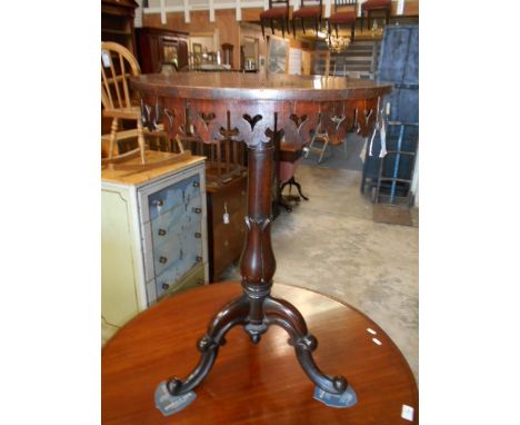 A Victorian circular rosewood side table with pierced heart shaped frieze, raised on a floral carves column and scroll carved