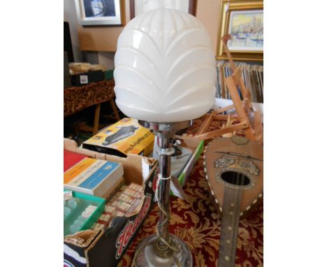 An art deco chrome table lamp of column form with moulded milk glass shade
