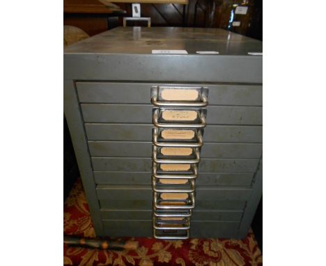 A ten drawer watchmakers chest housing various spare watch parts and tools