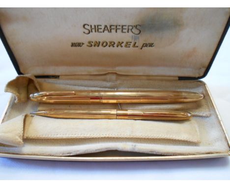 A 1950's Sheaffer Triumph Snorkel 14k gold filled fountain pen with engine turned decoration along with matching mechanical p
