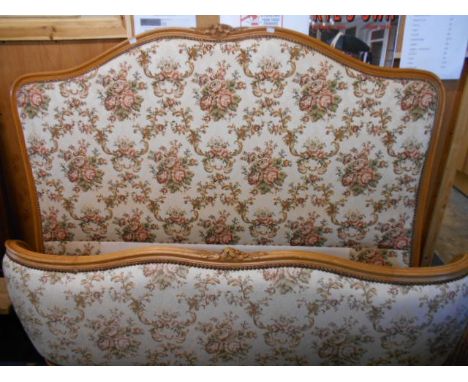 A French 4ft 6" walnut framed double bed upholstered in floral tapestry style fabric with floral carved head and foot boards