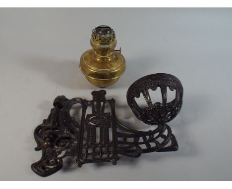A Pierced Metal Swivel Wall Bracket Holding Brass Oil Lamp 