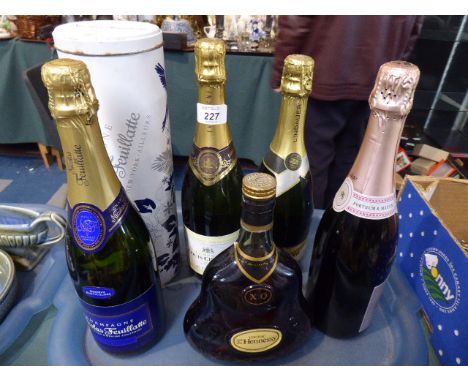 A Collection of Three Bottles of Champagne, One Bottle Hennessy Cognac and One Bottle New Zealand Sparkling Wine  
