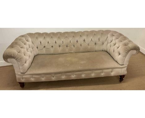 A 19th century button upholstered Chesterfield settee, raised on ring turned legs to castors.