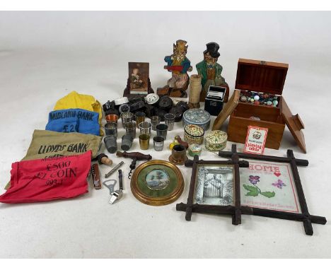 A collectors' lot, including marbles, bookends, bakelite light switches, bank bags, thimble full cups, corkscrew, sewing item