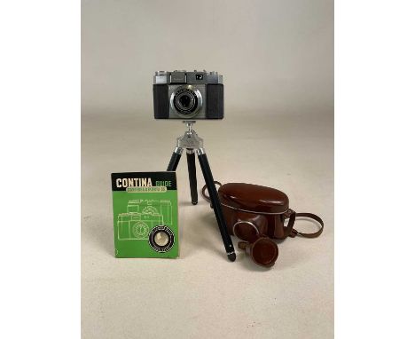 A Zeiss Contina Prontor- SVS 35 mm camera, with a rising tripod and Contina guide book, also the original Zeiss leather case.