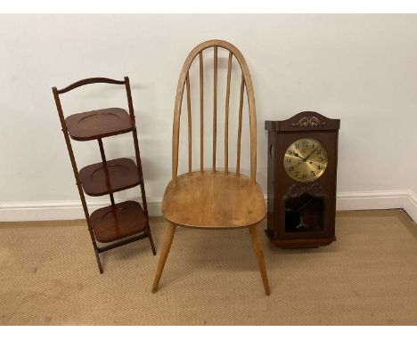 ERCOL; an elm and beech Quaker dining chair, together with an oak cased wall clock and a mahogany folding cake stand (3).