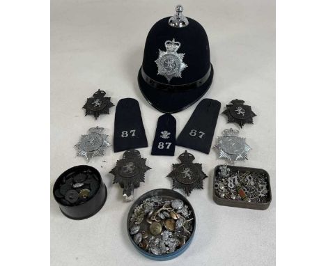 A Denbighshire police helmet and badges, to include shoulder epaulettes, various numbers and collar badges.