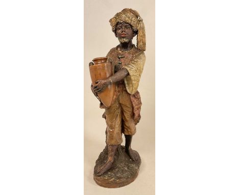 ATTRIBUTED TO GOLDSCHEIDER; a large terracotta painted figure of a Middle Eastern gentleman carrying an urn, height 72cm.