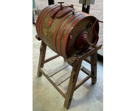 An antique butter churn on stand with red painted metal trim, marked Hathaway Maker, Chippenham, England, 116 x 72 x 58cm 