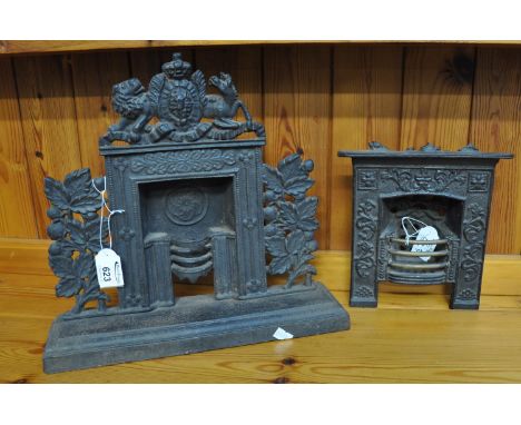 Novelty miniature cast iron mantelpiece ornament surrounded by crest and foliage, together with another. (2)(B.P. 21% + VAT) 