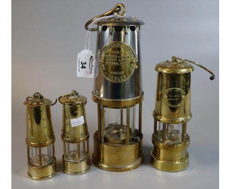 Protector Lamp & Lighting Co Ltd brass miner's safety lamp in unused condition, together with three small reproduction brass 