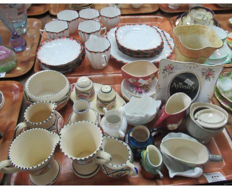 Two trays, one of Melba bone china part teaware, having six scalloped edged saucers with five teacups, feather edged in orang