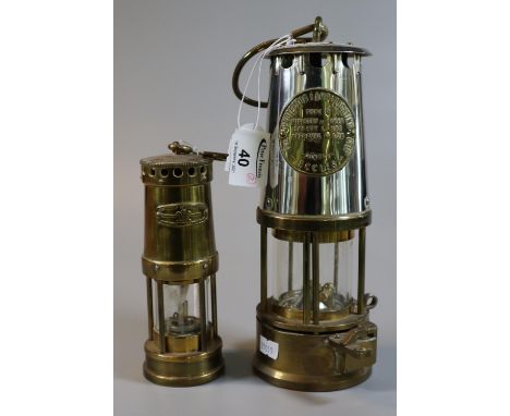 Protector Lamp & Lighting Co Ltd brass miner's safety lamp, appearing in unused condition, together with a miniature brass mi
