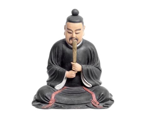 A FINE JAPANESE PAINTED WOOD DAISHOGUNEdo PeriodWith separately modelled head, seated with the legs crossed and concealed ben
