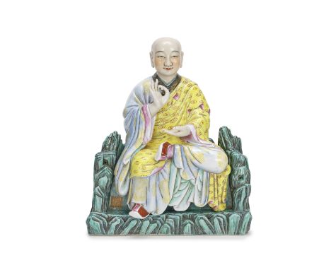 A FAMILLE ROSE FIGURE OF A MONKQianlong seal mark, 20th centurySeated in meditation on a separate turquoise rockwork throne, 