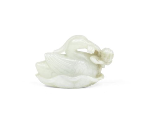 A PALE GREEN JADE 'DUCK AND LOTUS' CARVING18th/19th centuryThe crested bird holding a flowering lotus stem in its beak and re