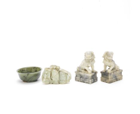 A PALE GREEN JADE 'MOUNTAIN' GROUP, A SPINACH GREEN JADE BOWL AND A PAIR OF 'BUDDHIST LION' CARVINGS18th/19th Century to late
