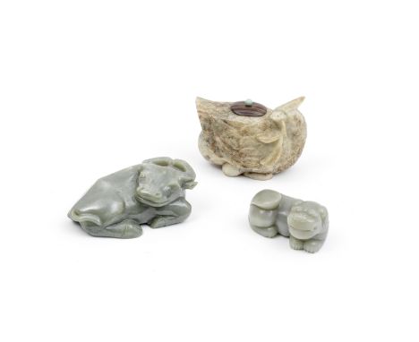 A GROUP OF THREE JADE ANIMAL CARVINGSComprising: a pale green jade recumbent water buffalo, the head turned to the right to l