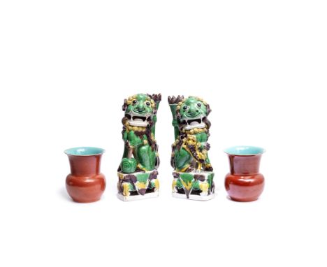 A PAIR OF FAMILLE VERTE BISCUIT 'LION' JOSS STICK HOLDERS AND A PAIR OF CORAL GLAZED ZHADOUKangxi and 19th centuryThe Buddhis