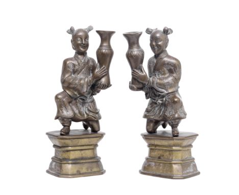 A PAIR OF COPPER ALLOY 'BOYS' JOSS STICK HOLDERS AND STANDS19th centuryThe kneeling boys modelled in mirror image, raised on 